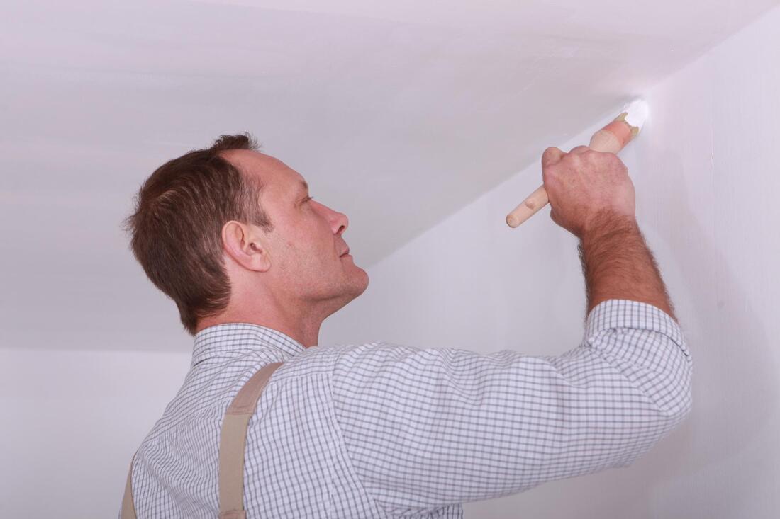 man painting a ceiling